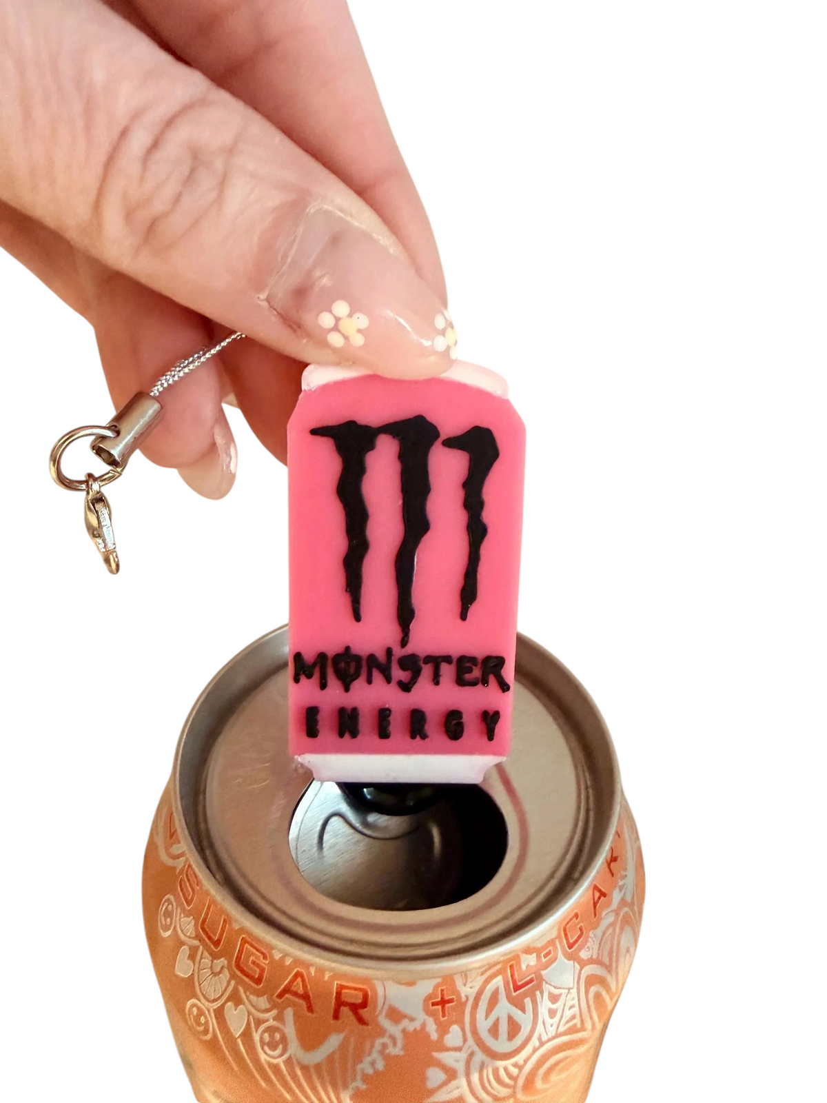 Pink Monster-inspired PopOff can tab opener keychain held above a drink can