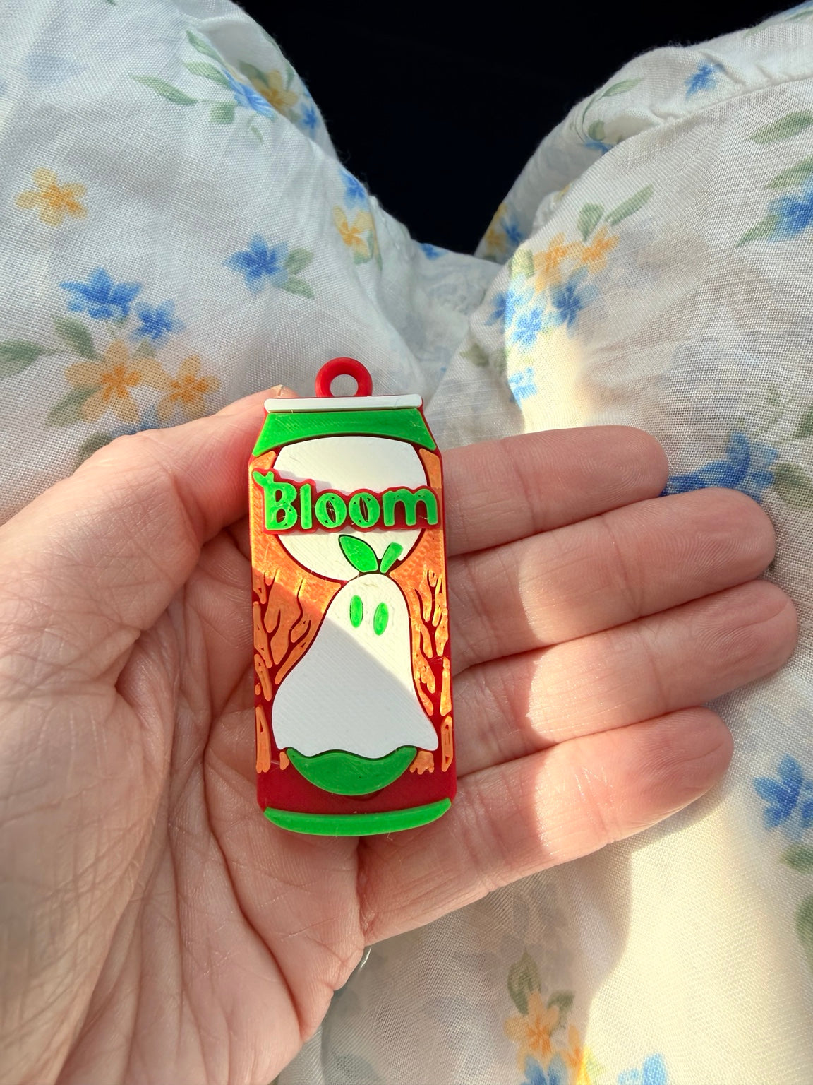 Ghosted by Fall miniature can tab opener shown in hand for scale
