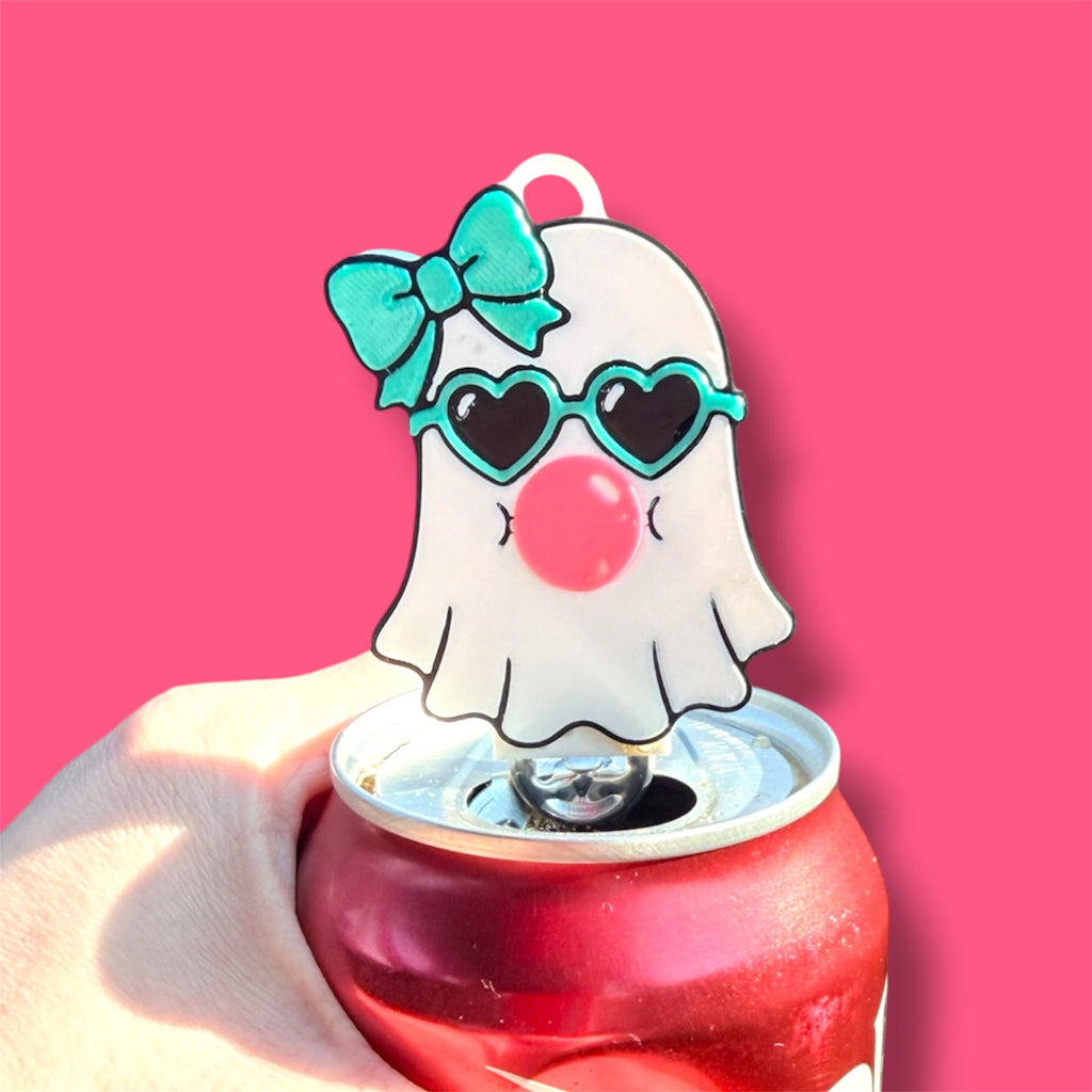 Pocket Magic ghost-themed can tab opener with heart sunglasses, teal bow, and bubblegum on a red soda can