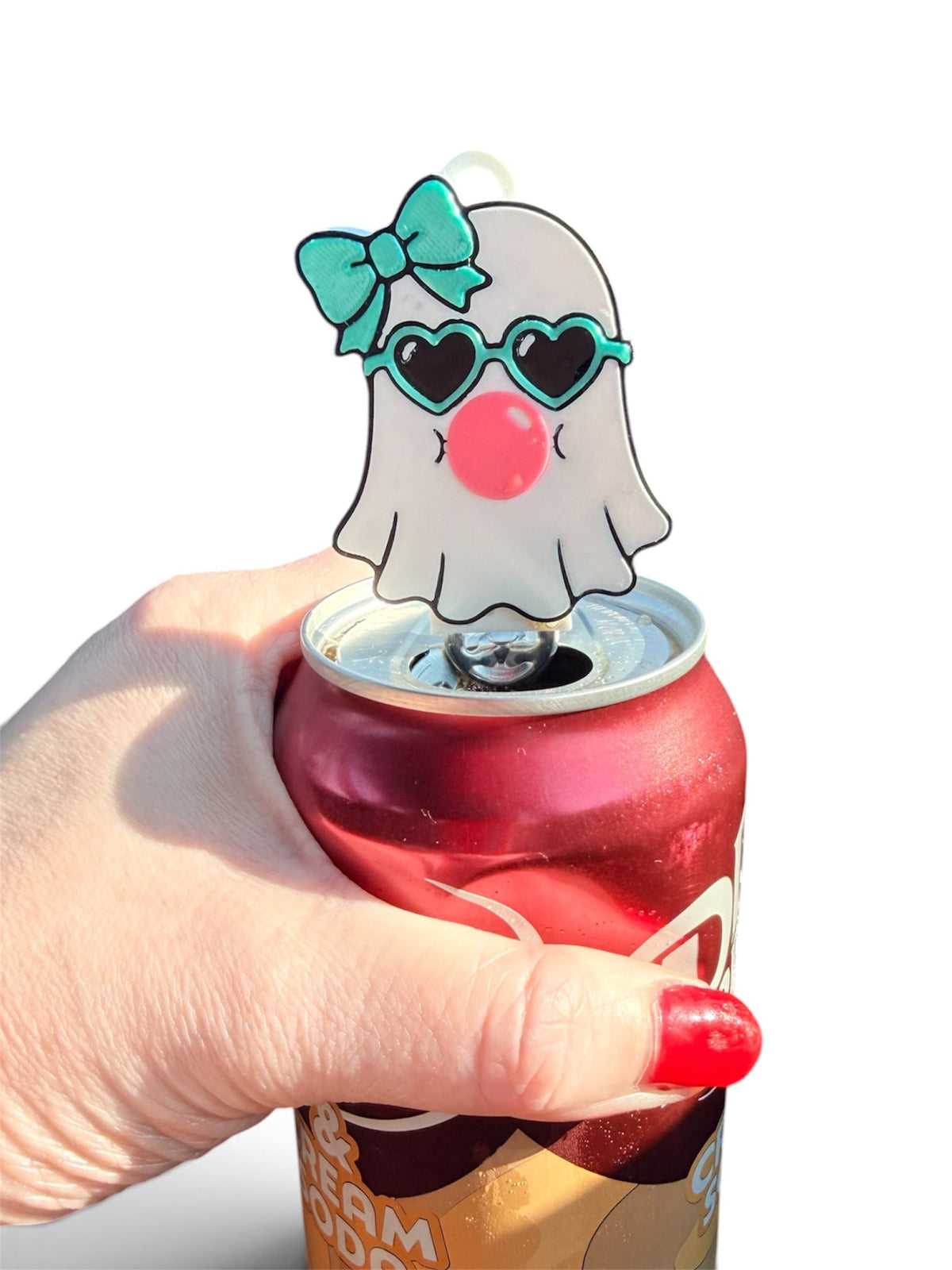 Pocket Magic ghost can tab opener with teal bow and heart sunglasses on a red soda can
