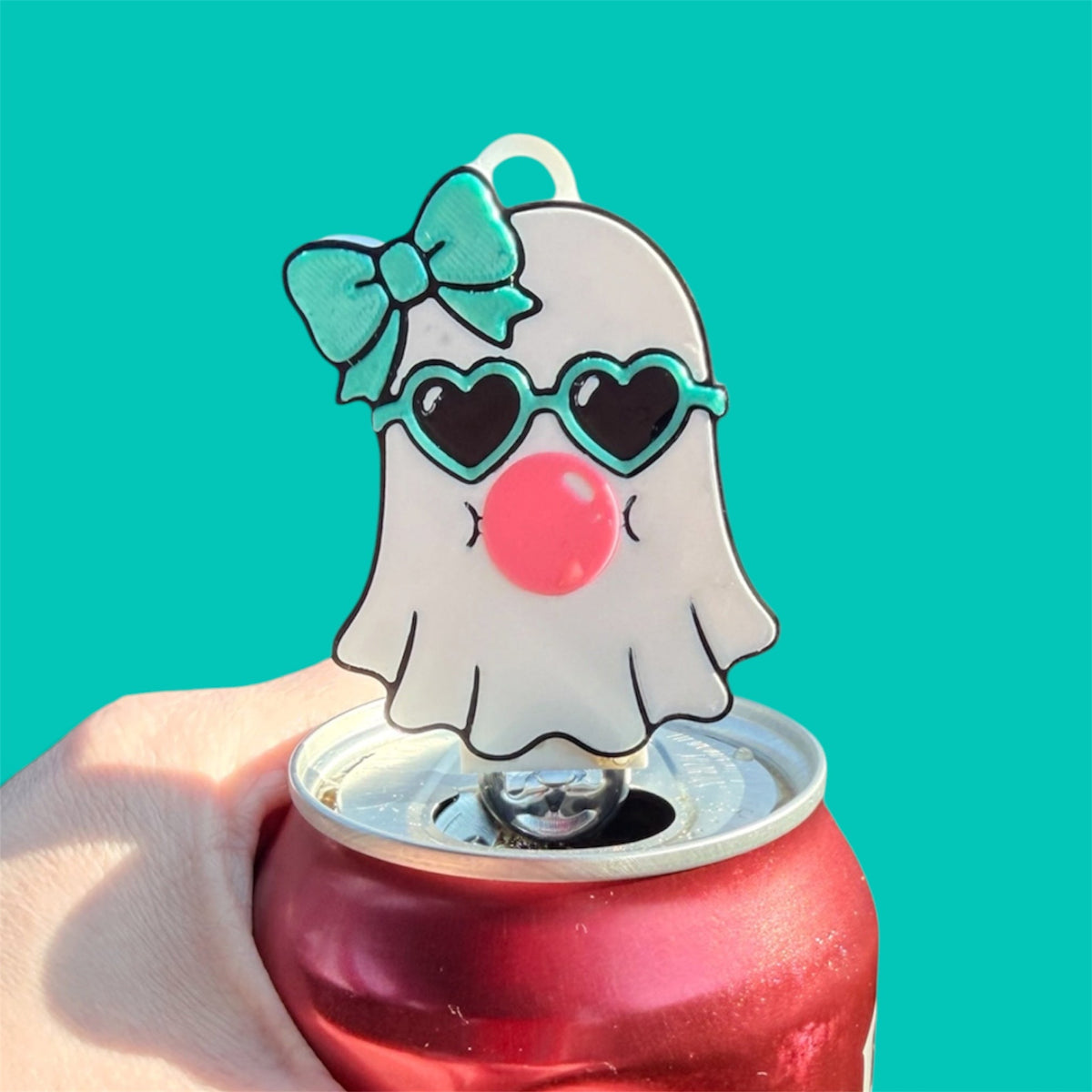 Pocket Magic ghost can opener keychain with heart sunglasses, teal bow, and bubblegum on a red soda can