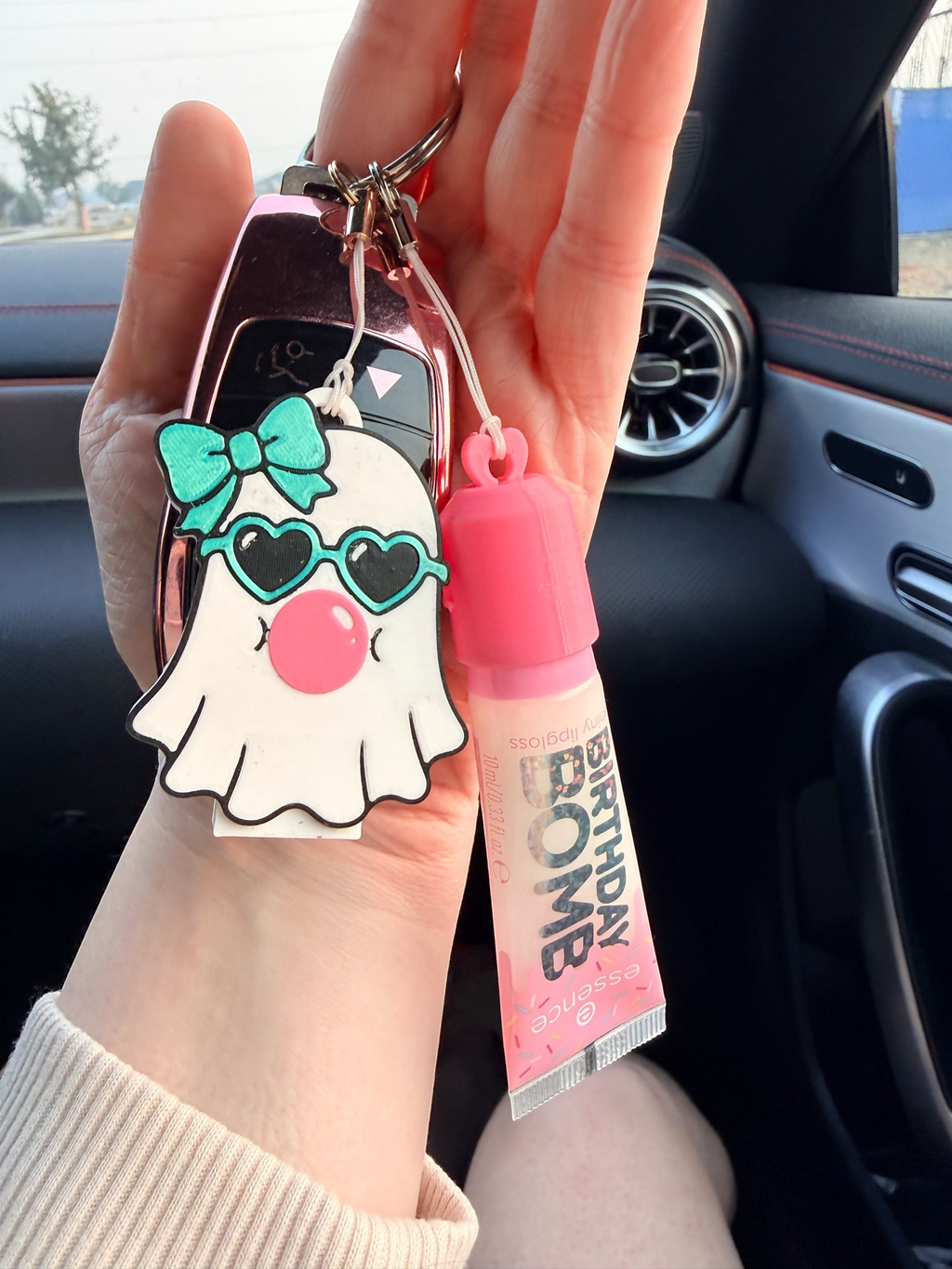 Pocket Magic lip gloss and ghost keychain set with a pink tube and cute ghost charm featuring sunglasses and a bow