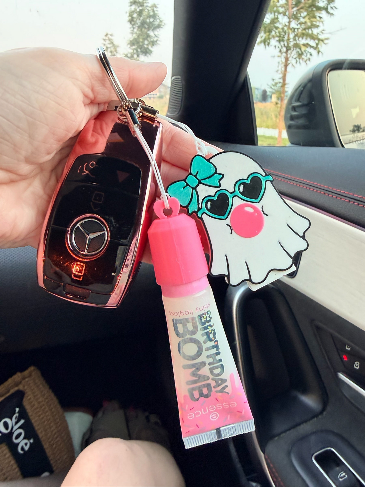 Pocket Magic lip gloss and ghost keychain accessory set with a pink tube and cute ghost charm attached to car keys.