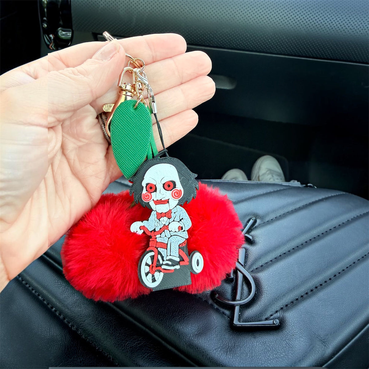 Horror-inspired Puzzle Night PopOff keychain displayed on a red pom bag