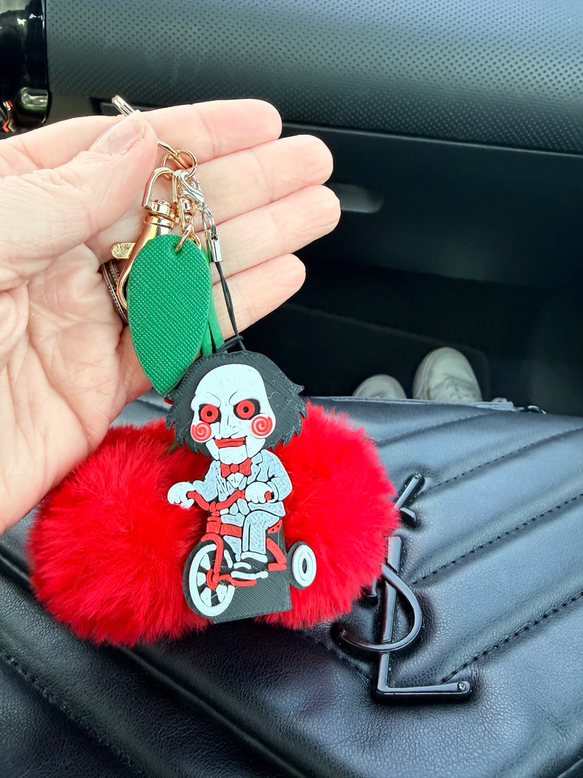 Puzzle Night horror-inspired PopOff keychain clipped with everyday bag accessories